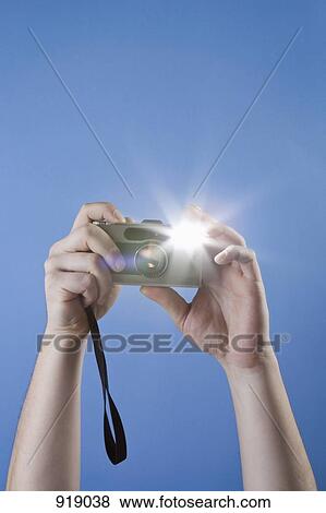 Detail of a man taking a photograph with a digital camera View Large Photo Image Stock Photo - Detail of a man taking a photograph with a digital camera. Fotosearch
