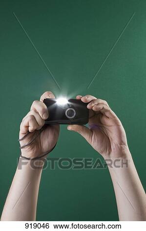 Detail of a man taking a photograph with a digital camera View Large Photo Image Stock Photograph - Detail of a man taking a photograph with a digital camera. Fotosearch