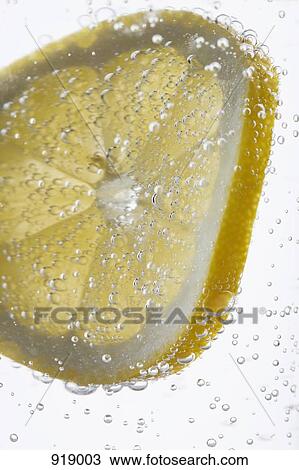 Detail of a slice of lemon in water View Large Photo Image Stock Image - Detail of a slice of lemon in water. Fotosearch