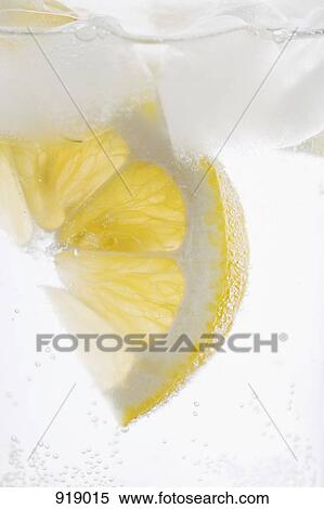 Detail of a slice of lemon in water View Large Photo Image Stock Photography - Detail of a slice of lemon in water. Fotosearch