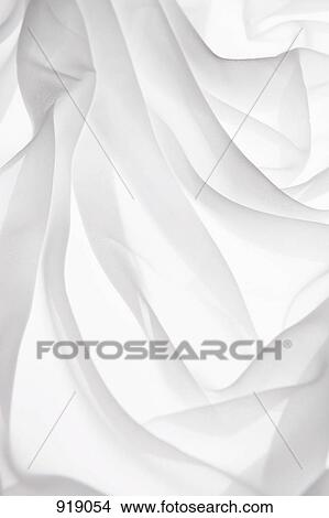 Picture - Detail of folded white fabric on a light box. Fotosearch