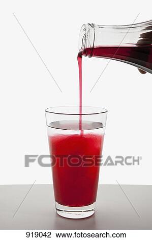Detail of fruit syrup being poured into a glass of water View Large Photo Image Stock Image - Detail of fruit syrup being poured into a glass of water. Fotosearch