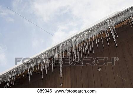 Detail of icicles hanging from a roof View Large Photo Image Stock Photograph - Detail of icicles hanging from a roof. Fotosearch