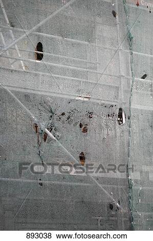 Stock Photo - Detail of protective netting and scaffolding. Fotosearch