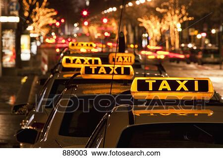 Detail of taxi cabs parked in a row at night View Large Photo Image Stock Image - Detail of taxi cabs parked in a row at night. Fotosearch