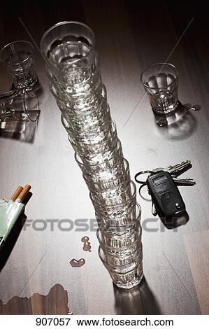 Stock Photo - Glasses Stacked On Top Of Each Other On A Messy Table. Fotosearch