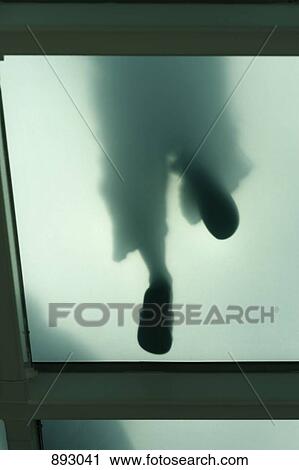 Legs and feet seen through a glass flooring, directly below View Large Photo Image Stock Image - Legs and feet seen through a glass flooring, directly below. Fotosearch