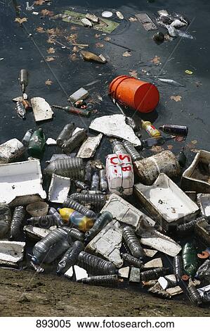 Litter floating in dirty water View Large Photo Image Stock Photography - Litter floating in dirty water. Fotosearch