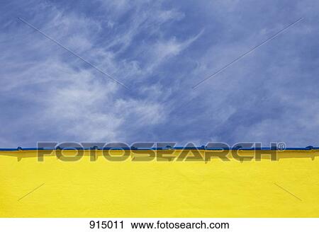 Stock Image - Low angle close up view of a wall and sky. Fotosearch
