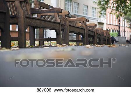 Low view of wooden benches in a park View Large Photo Image Stock Photograph - Low view of wooden benches in a park. Fotosearch