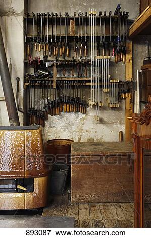 Stock Photo - New and old vices hanging in a woodworkers workshop. Fotosearch