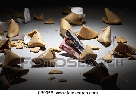 Stock Photo - Open fortunes cookies with messages and money. Fotosearch