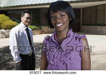 Portrait of a businesswoman, man in background, focus on woman View Large Photo Image Stock Photo - Portrait of a businesswoman, man in background, focus on woman. Fotosearch
