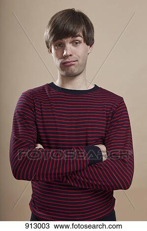 Portrait of a man looking doubtful, studio shot View Large Photo Image Stock Image - Portrait of a man looking doubtful, studio shot. Fotosearch