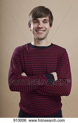 Portrait of a man looking happy, studio shot View Large Photo Image Stock Photograph - Portrait of a man looking happy, studio shot. Fotosearch