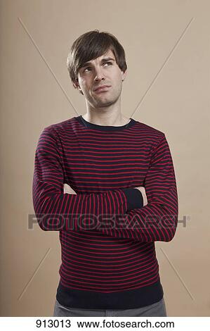Portrait of a man looking up uncertainly, studio shot View Large Photo Image Stock Image - Portrait of a man looking up uncertainly, studio shot. Fotosearch
