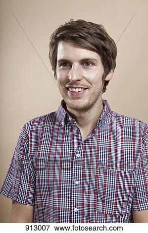 Portrait of a man with a goofy smile, looking away, studio shot View Large Photo Image Stock Photo - Portrait of a man with a goofy smile, looking away, studio shot. Fotosearch