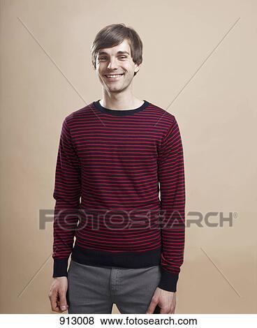 Stock Photo - Portrait of a man with a relaxed smile, studio shot. Fotosearch