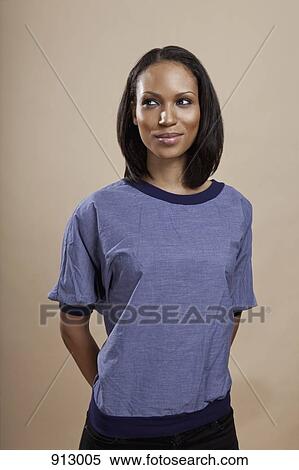 Portrait of a woman looking mischievous, studio shot View Large Photo Image Stock Photography - Portrait of a woman looking mischievous, studio shot. Fotosearch