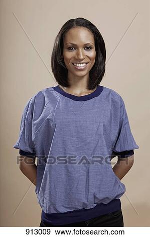 Stock Photo - Portrait of a woman smiling, studio shot. Fotosearch