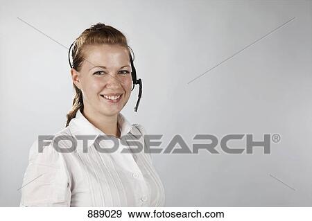Portrait of a young woman wearing a headset View Large Photo Image Stock Photo - Portrait of a young woman wearing a headset. Fotosearch