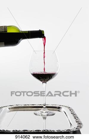 Red wine being poured into a wineglass on a tray View Large Photo Image Stock Image - Red wine being poured into a wineglass on a tray. Fotosearch
