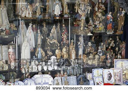 Picture - Religious icons and paraphernalia arranged in a store window. Fotosearch