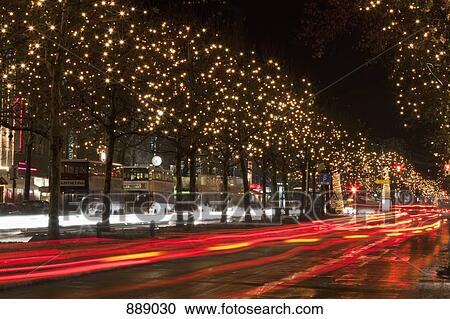 Stock Image - Scene with moving traffic and trees decorated with lights, Unter Den Linden, Berlin, Germany. Fotosearch
