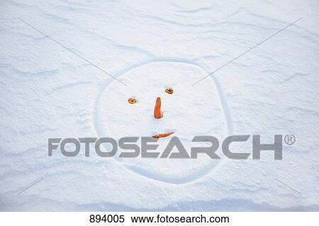 Stock Photography - Snowman's face made in the snow. Fotosearch