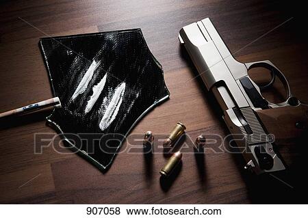 Stock Photo - Still Life Of A Handgun, Bullets And Lines Of Cocaine. Fotosearch
