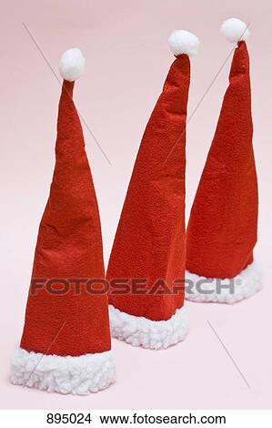 Picture - Three Santa hats in a row. Fotosearch
