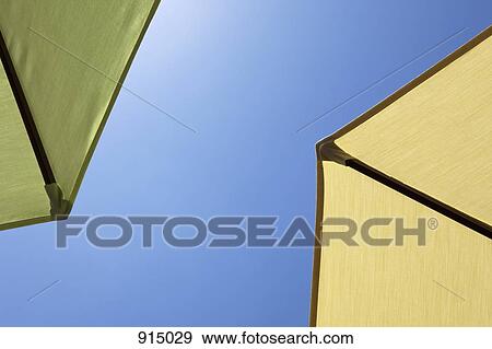 Two beach umbrellas, close-up, directly below View Large Photo Image Stock Photo - Two beach umbrellas, close-up, directly below. Fotosearch