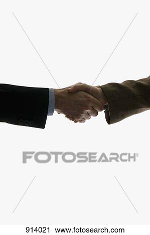 Two business people shaking hands, focus on hands View Large Photo Image Stock Image - Two business people shaking hands, focus on hands. Fotosearch