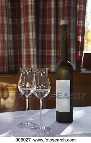 Stock Photo - Two glasses and a bottle of Schnapps. Fotosearch