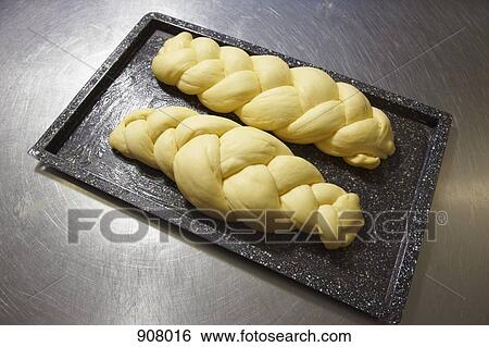 Two loaves of braided bread waiting to be baked View Large Photo Image Stock Photograph - Two loaves of braided bread waiting to be baked. Fotosearch