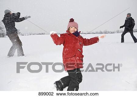 Two parents and their daughters having a snowball fight View Large Photo Image Stock Image - Two parents and their daughters having a snowball fight. Fotosearch