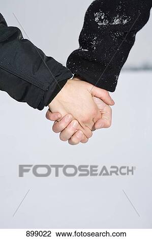 Two people holding hands, detail shot of the hands View Large Photo Image Stock Image - Two people holding hands, detail shot of the hands. Fotosearch