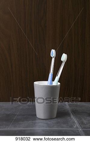 Two toothbrushes in a ceramic cup View Large Photo Image Stock Image - Two toothbrushes in a ceramic cup. Fotosearch
