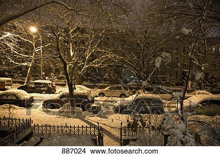 Picture - View of a snowy street from a front stoop at night, Brooklyn, New York, USA. Fotosearch