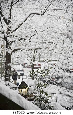 Stock Image - View of a snowy street from a front stoop, Brooklyn, New York, USA. Fotosearch