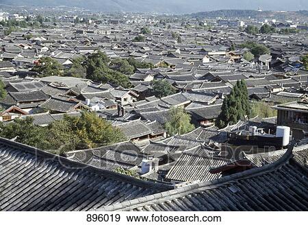 Stock Photo - View over rooftops of the old town, Lijiang, Yunnan Province, China. Fotosearch