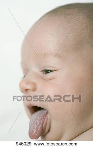 Stock Photo - A baby sticking out his tongue, close-up. Fotosearch
