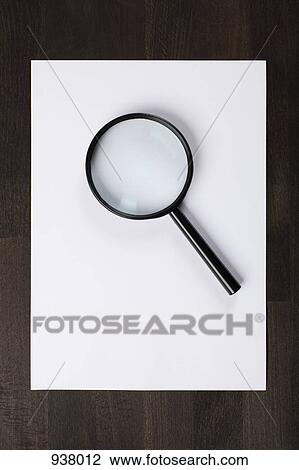 A blank piece of paper and a magnifying glass View Large Photo Image Stock Image - A blank piece of paper and a magnifying glass. Fotosearch
