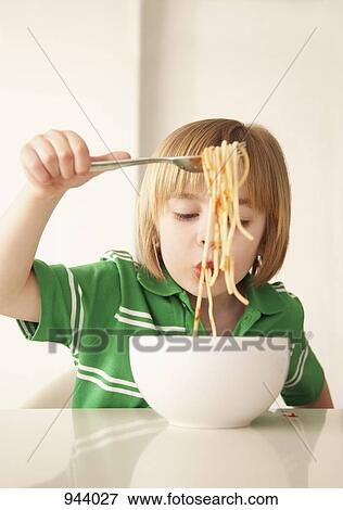 A boy eating spaghetti View Large Photo Image Stock Photo - A boy eating spaghetti. Fotosearch