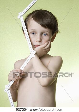 A boy holding a folding ruler View Large Photo Image Picture - A boy holding a folding ruler. Fotosearch