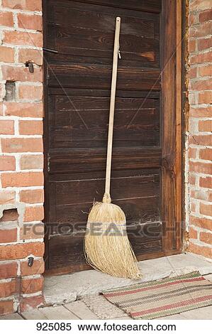 Stock Photography - A broom leaning against a door. Fotosearch