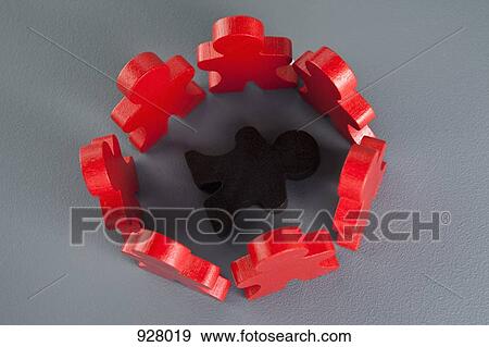 Stock Photo - A brown wooden stick figure surrounded by a circle of red wooden stick figures. Fotosearch