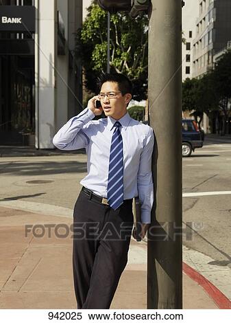A businessman using a mobile View Large Photo Image Stock Photography - A businessman using a mobile. Fotosearch