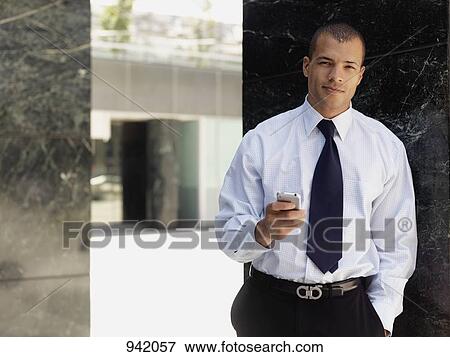 A businessman using a smart phone View Large Photo Image Stock Photo - A businessman using a smart phone. Fotosearch