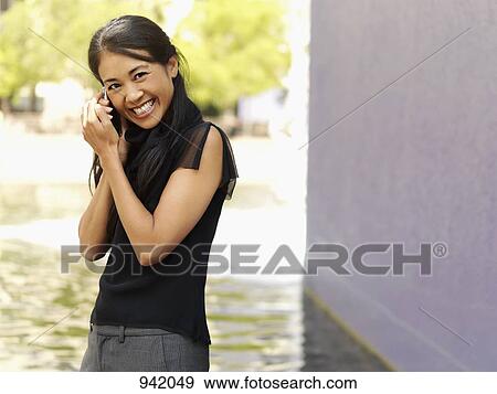 A businesswoman using a mobile phone View Large Photo Image Stock Photo - A businesswoman using a mobile phone. Fotosearch